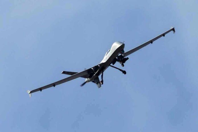 military drone flying in a clear blue sky