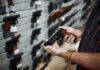 Gun Shop Panic: Chilling ICE Threats – Lawyer Nabbed Fast Person holding a handgun in a gun shop
