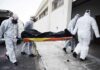 Siberia Quarantine After Lab Worker Dies medical team in hazmat suits carrying a body on a stretcher