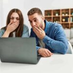 Weaponized Justice? Slotkin’s Stark Pitch Two people cover their mouths while looking at a laptop