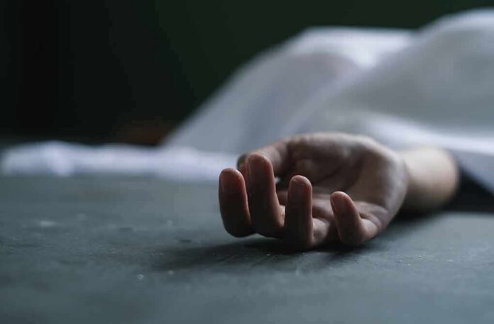 human hand lying on floor under white sheet