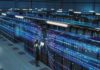 Rate Hike Panic Spurs Wild Trump Mandate Technician with laptop in a large data center aisle