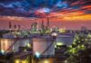 Gulf Flows Back – Hormuz Jitters Keep Gas Pain High Oil refinery with storage tanks at sunset