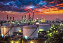 Gulf Flows Back – Hormuz Jitters Keep Gas Pain High Oil refinery with storage tanks at sunset