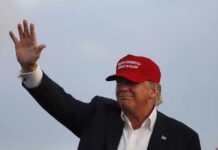 Celebrity Jolt Supercharges Trump’s Michigan Push Donald Trump waving in a red cap