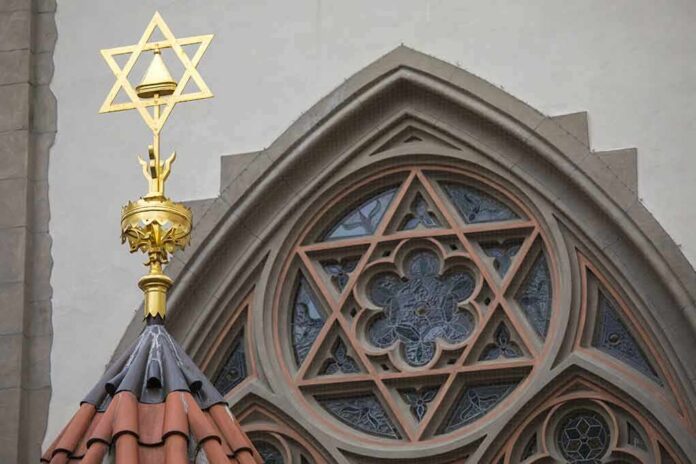 Star of David atop synagogue roof with stained glass window